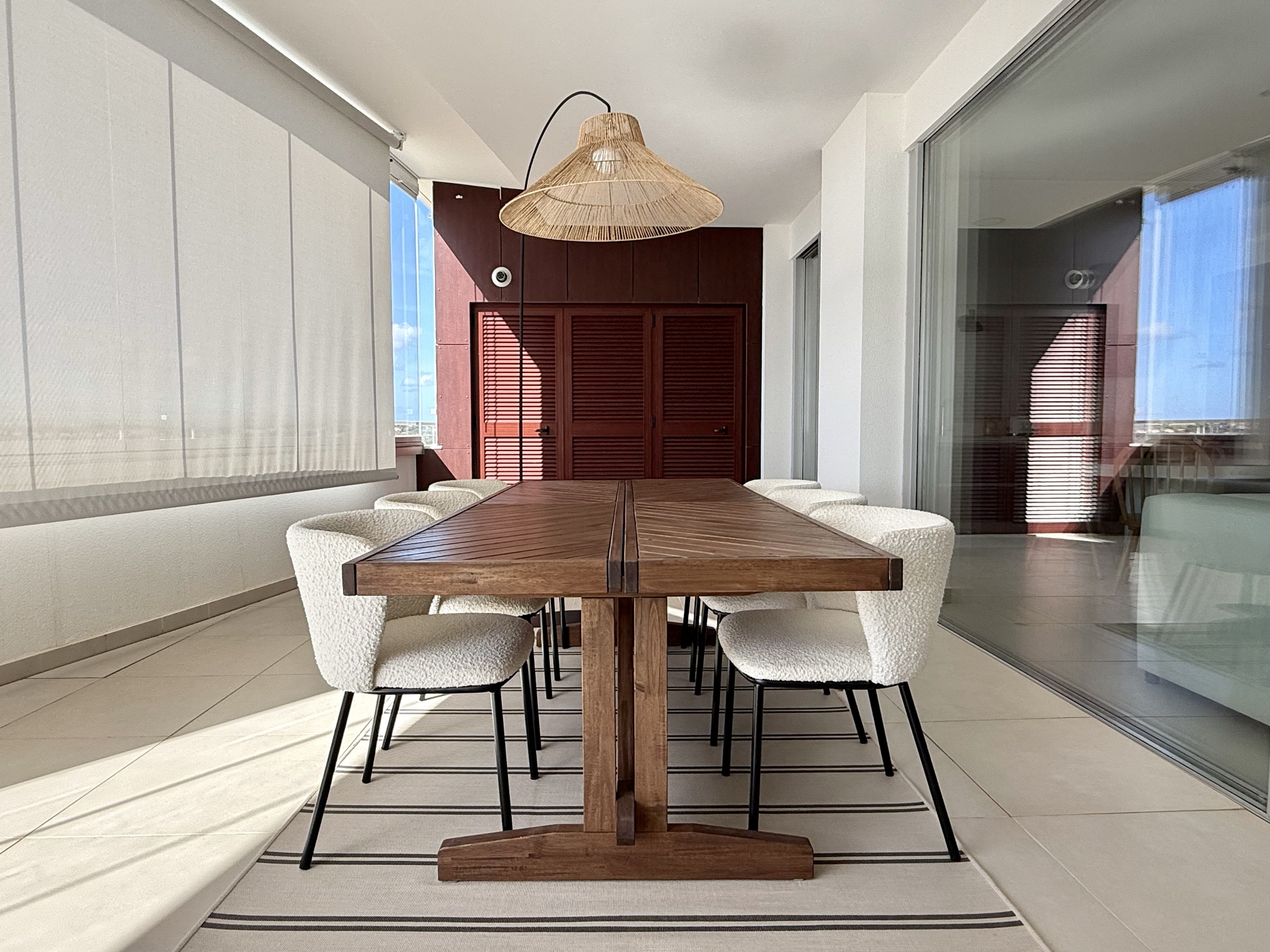 Terrace dining table enclosed by glass curtains